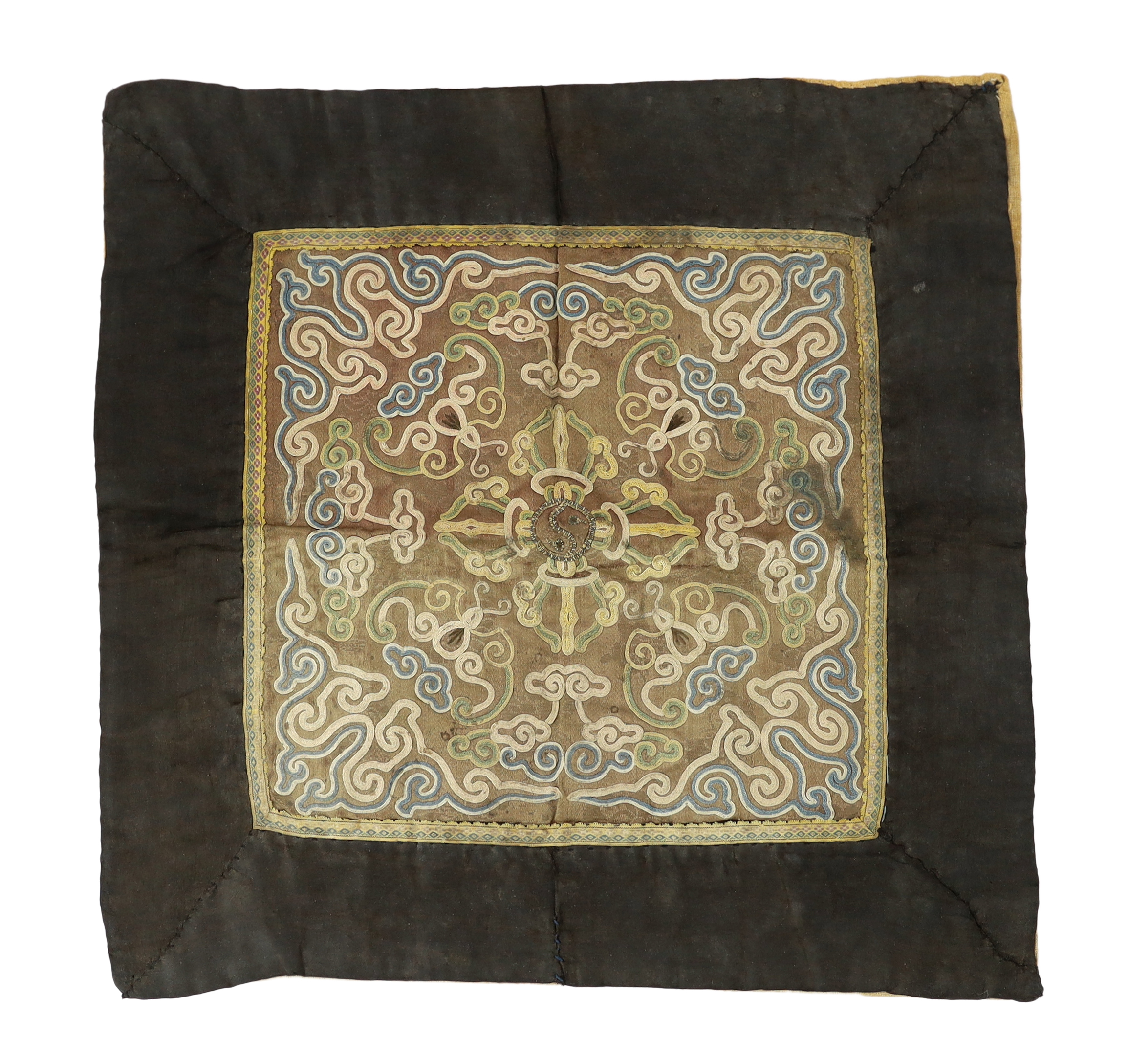A Tibetan embroidered silk 'vajra' panel, 17th / 18th century, faded and stained